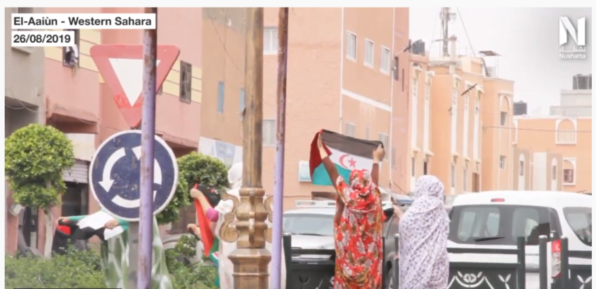 Western Sahara: Saharawi women holding Western Sahara flags